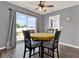 Bright dining room with hardwood floors, modern ceiling fan, and a view of the backyard at 2764 W Covington Dr, Deltona, FL 32738