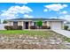 Charming single-story home with a well-manicured front yard, long driveway, and a white picket fence at 2764 W Covington Dr, Deltona, FL 32738