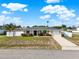 Charming single-story home with a well-manicured front yard, long driveway, and a white picket fence at 2764 W Covington Dr, Deltona, FL 32738