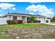 Charming single-story home with a well-manicured front yard, long driveway, and a white picket fence at 2764 W Covington Dr, Deltona, FL 32738
