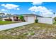 Charming single-story home with a well-manicured front yard, long driveway, and a white picket fence at 2764 W Covington Dr, Deltona, FL 32738