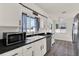 Bright kitchen featuring white cabinets, modern appliances, and stylish accents at 2764 W Covington Dr, Deltona, FL 32738