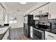 Modern kitchen with stainless steel appliances, a patterned backsplash, and wood-style flooring at 2764 W Covington Dr, Deltona, FL 32738