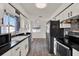 Well-lit kitchen featuring sleek appliances, efficient layout, and stylish backsplash at 2764 W Covington Dr, Deltona, FL 32738