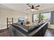 The open living room features wood-look floors, a ceiling fan, modern lighting, and a large window at 2764 W Covington Dr, Deltona, FL 32738
