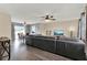 Open-concept living room with wood-look floors, a ceiling fan, a dining area, and a view to the backyard at 2764 W Covington Dr, Deltona, FL 32738