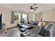 Living room featuring hardwood floor, large leather sofa, and natural light at 2764 W Covington Dr, Deltona, FL 32738
