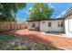 Backyard featuring a mulched area, grass, fence, and the exterior of home at 2903 E Michigan St, Orlando, FL 32806