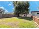 Backyard featuring a large grassy area, a fence and the exterior of the home at 2903 E Michigan St, Orlando, FL 32806