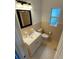 Bathroom features a white vanity, toilet, and neutral wall tile at 2903 E Michigan St, Orlando, FL 32806