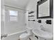 Bright bathroom with white tiled walls, modern fixtures, and ample storage at 2903 E Michigan St, Orlando, FL 32806