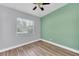 Bedroom featuring wood-look floors, a modern ceiling fan, and ample natural light at 2903 E Michigan St, Orlando, FL 32806