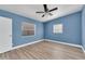 Bedroom featuring modern flooring, windows with blinds, and a ceiling fan at 2903 E Michigan St, Orlando, FL 32806