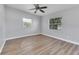 Bedroom featuring modern flooring, windows with blinds, and a ceiling fan at 2903 E Michigan St, Orlando, FL 32806