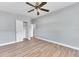 Bedroom featuring wood-look floors, ceiling fan, and a closet for ample storage at 2903 E Michigan St, Orlando, FL 32806