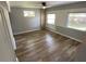 This bedroom features wood-look floors and multiple windows for natural light at 2903 E Michigan St, Orlando, FL 32806