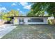 Stylish home featuring a bright yellow front door and a covered carport at 2903 E Michigan St, Orlando, FL 32806