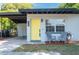 Welcoming front entrance with a bright yellow door and cozy seating area at 2903 E Michigan St, Orlando, FL 32806