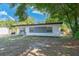 Charming home with a freshly painted exterior, xeriscaping and a yellow front door at 2903 E Michigan St, Orlando, FL 32806