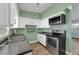 Bright kitchen with stainless steel appliances, a stylish countertop, and modern white cabinets at 2903 E Michigan St, Orlando, FL 32806