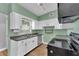 Well-lit kitchen features white cabinets, stainless steel appliances, and modern finishes at 2903 E Michigan St, Orlando, FL 32806