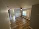 Open living room boasts wood-look floors, natural light, and neutral paint at 2903 E Michigan St, Orlando, FL 32806
