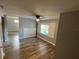 Open living room boasts wood-look floors, natural light, and neutral paint at 2903 E Michigan St, Orlando, FL 32806