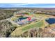 Aerial view of a community with modern homes, golf courses, and ponds, offering a serene and luxurious lifestyle at 3024 Kensington Ave, Davenport, FL 33837