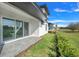 Backyard features green grass, manicured landscape beds and a view of neighboring homes at 3024 Kensington Ave, Davenport, FL 33837
