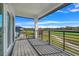 Balcony overlooking a golf course, features metal railings and wooden decking at 3024 Kensington Ave, Davenport, FL 33837