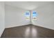 Bright bedroom features hardwood floors, neutral walls, and lots of natural light from the two windows at 3024 Kensington Ave, Davenport, FL 33837