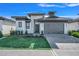 Modern home exterior showcasing manicured lawn, stone facade, and a sleek garage door at 3024 Kensington Ave, Davenport, FL 33837
