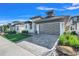 Modern home featuring a well-manicured lawn, stone accents, and a sleek garage door at 3024 Kensington Ave, Davenport, FL 33837