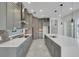 Well-equipped kitchen boasting gray cabinets, quartz countertops, and stainless steel appliances at 3024 Kensington Ave, Davenport, FL 33837