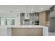 Stylish kitchen featuring a large island, pendant lighting, and glass-front cabinets at 3024 Kensington Ave, Davenport, FL 33837