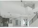 Bright living room features soaring ceilings, an open floorplan, and stairs to the upper level at 3024 Kensington Ave, Davenport, FL 33837