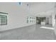 Bright living room features soaring ceilings, an open floorplan, and lots of natural light at 3024 Kensington Ave, Davenport, FL 33837
