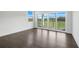 Bright living room features hardwood flooring, large glass doors, and exterior views at 3024 Kensington Ave, Davenport, FL 33837