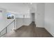 Upstairs loft area with hardwood flooring, metal railing, and bright, neutral color palette at 3024 Kensington Ave, Davenport, FL 33837