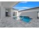 Inviting backyard pool and spa features a waterfall, patio, and seamless indoor/outdoor living at 3024 Kensington Ave, Davenport, FL 33837