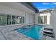 Inviting backyard pool and spa features a waterfall, patio, and seamless indoor/outdoor living at 3024 Kensington Ave, Davenport, FL 33837