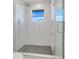 Modern shower features marble-look tile, glass enclosure, and overhead rain shower head at 3024 Kensington Ave, Davenport, FL 33837
