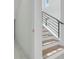 Modern staircase features white risers and wooden treads, black iron railing and natural light at 3024 Kensington Ave, Davenport, FL 33837