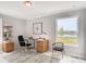 Comfortable home office featuring wood-look flooring and natural lighting at 3028 Water Clover Ct, Apopka, FL 32712