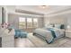 Comfortable main bedroom with tray ceiling and water views at 3028 Water Clover Ct, Apopka, FL 32712