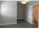 Neutral bedroom with ceiling fan, wood-look floors, and connecting door to the bathroom at 3060 George Mason Ave # 10C, Winter Park, FL 32792