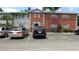 Traditional two-story brick apartment building with ample parking spaces and manicured landscaping at 3060 George Mason Ave # 10C, Winter Park, FL 32792