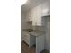 Modern kitchen featuring granite countertops, white cabinets, and stainless steel sink at 3060 George Mason Ave # 10C, Winter Park, FL 32792