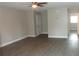Bright living room with wood-look floors, neutral paint, ceiling fan, and welcoming atmosphere at 3060 George Mason Ave # 10C, Winter Park, FL 32792