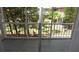 Enclosed patio with views of the trees and grassy green space around the property at 3060 George Mason Ave # 10C, Winter Park, FL 32792